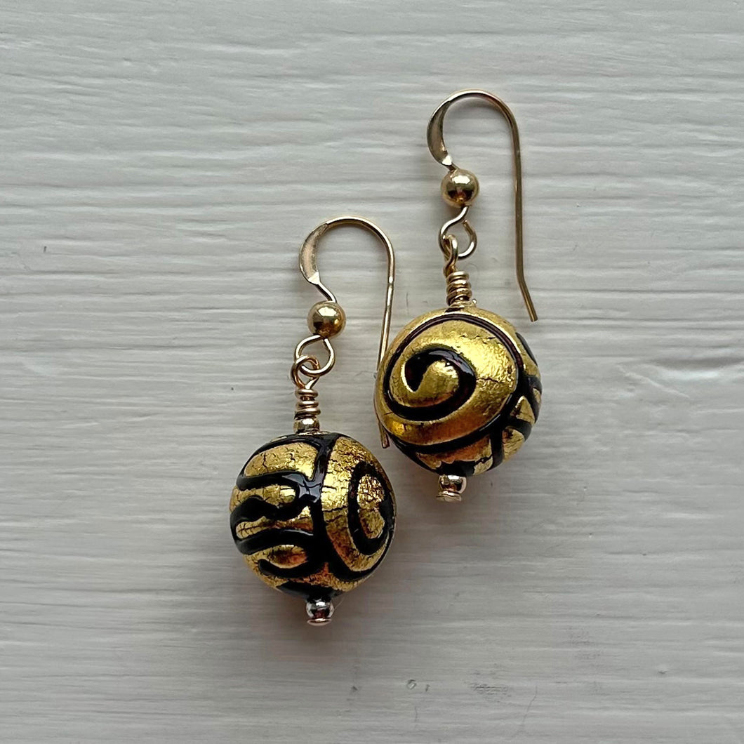 Earrings with black pastel appliqué Aztec over gold Murano glass small sphere drops