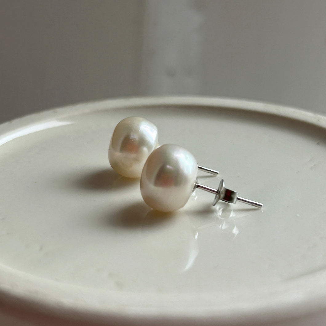 Pearl earrings with large white cultured freshwater near round studs on surgical steel posts