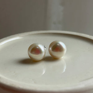 Pearl earrings with large white cultured freshwater near round studs on surgical steel posts