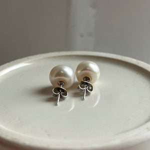 Pearl earrings with large white cultured freshwater near round studs on surgical steel posts