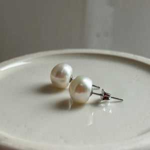 Pearl earrings with medium white cultured freshwater near round studs on surgical steel posts