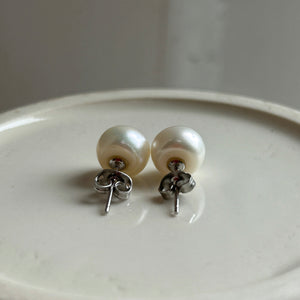 Pearl earrings with medium white cultured freshwater near round studs on surgical steel posts