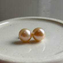 Pearl earrings with large pink cultured freshwater near round studs on surgical steel posts