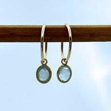 Gemstone earrings with aquamarine (blue) oval crystal drops on gold small hoops