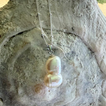 Necklace with large white baroque double conjoined pearl pendant on silver satellite chain
