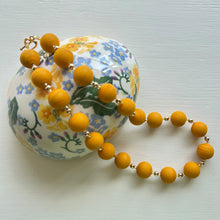 Necklace with matt yellow ochre pastel Murano glass small sphere beads on gold beads and clasp