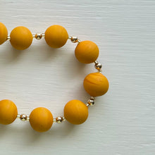 Necklace with matt yellow ochre pastel Murano glass small sphere beads on gold beads and clasp