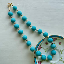 Necklace with matt turquoise pastel Murano glass small sphere beads on gold beads and clasp
