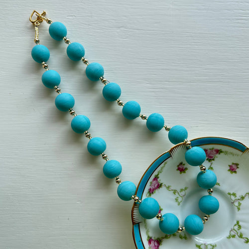 Necklace with matt turquoise pastel Murano glass small sphere beads on gold beads and clasp