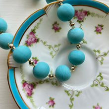 Necklace with matt turquoise pastel Murano glass small sphere beads on gold beads and clasp