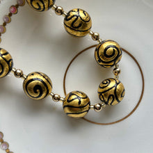 Necklace with black pastel appliqué Aztec over gold Murano glass sphere beads on gold