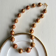 Necklace with Aztec red pastel appliqué over gold Murano glass sphere beads on gold