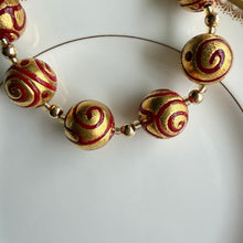 Necklace with Aztec red pastel appliqué over gold Murano glass sphere beads on gold