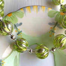 Necklace with light green appliqué over white gold Murano glass small sphere beads on silver