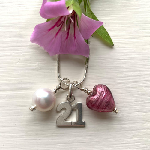 Three charm necklace in Sterling Silver with rose pink (cerise) glass heart, '21' and pearl