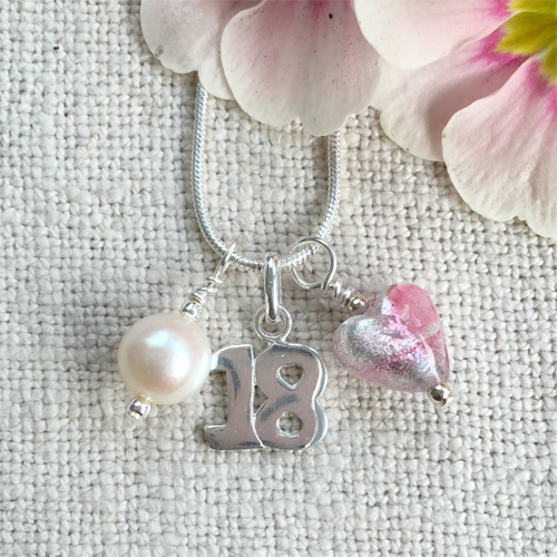 Three charm necklace in Sterling Silver with candy stripe pink glass heart, '18' and pearl