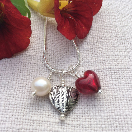 Three charm necklace in Sterling Silver with red Murano glass heart, etched heart and pearl