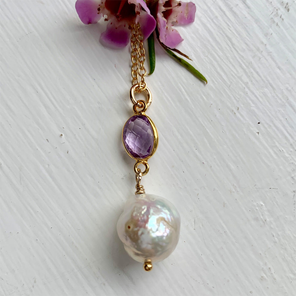 Gemstone necklace with amethyst (purple) crystal and large pearl pendant on gold chain