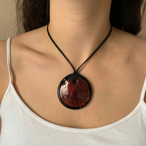 Necklace with burnt orange and gold on black Murano glass near circular large flat pendant