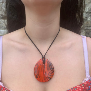 Necklace with orange pastel Murano glass near circular large flat pendant