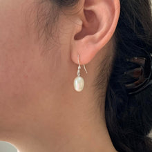 Pearl earrings with medium freshwater natural white oval pearl drops on silver hooks