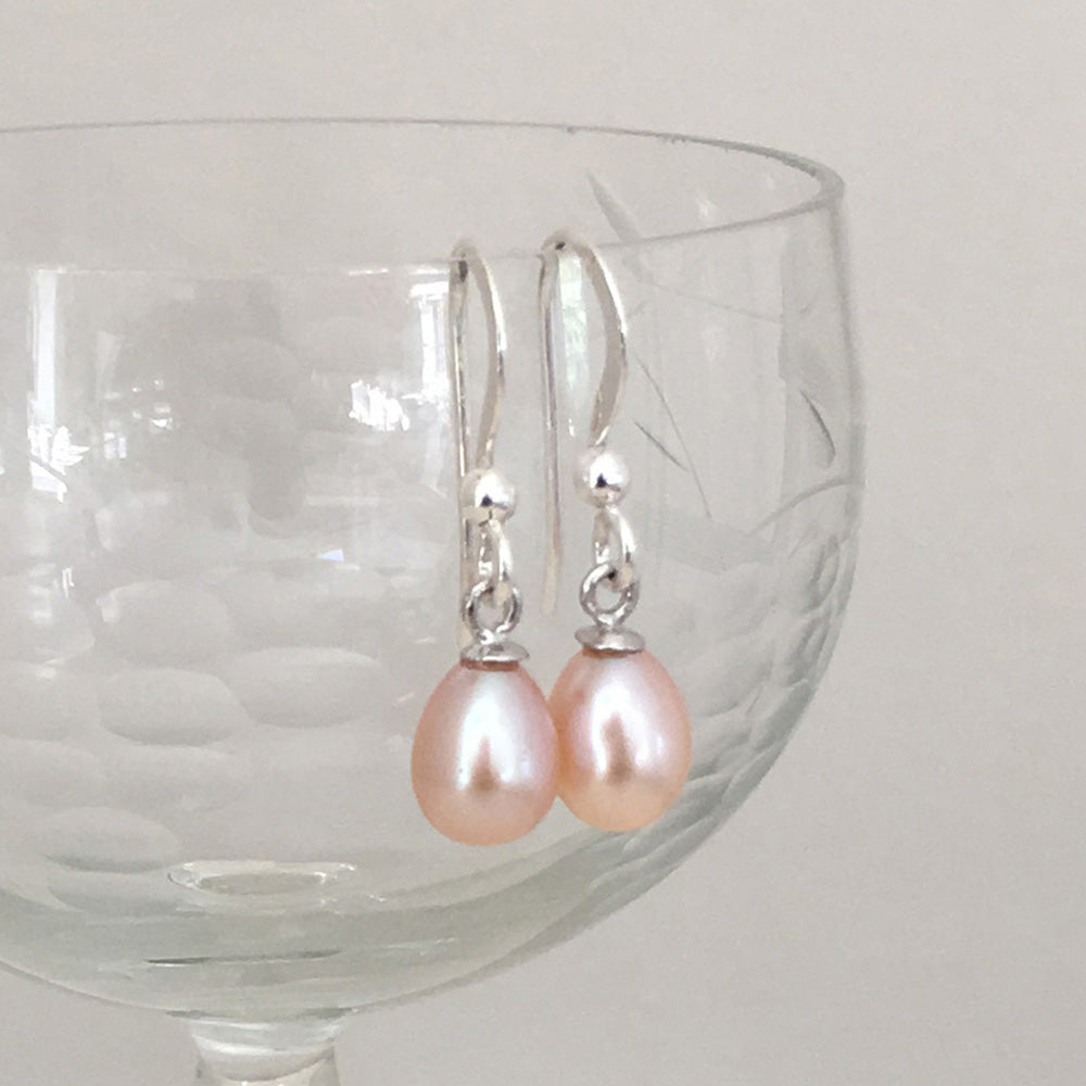 Pearl earrings with small freshwater natural pink oval pearl drops on silver hooks