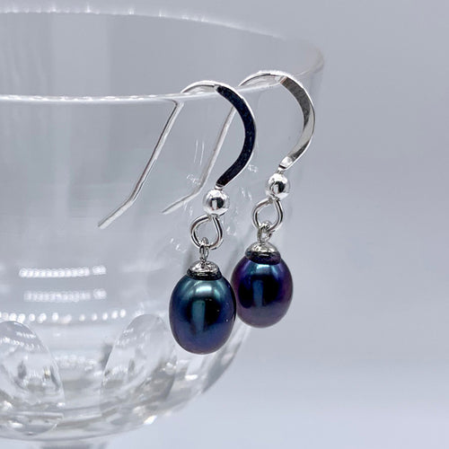 Pearl earrings with small freshwater natural black oval pearl drops on silver hooks