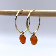 Gemstone earrings with carnelian (red) oval crystal drops on gold medium hoops