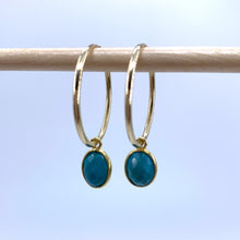Gemstone earrings with turquoise (blue) oval crystal drops on gold medium hoops