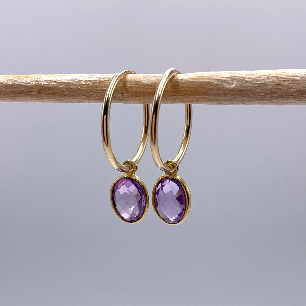 Gemstone earrings with amethyst (purple) oval crystal drops on gold small hoops