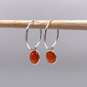 Gemstone earrings with carnelian (red) oval crystal drops on silver small hinged hoops