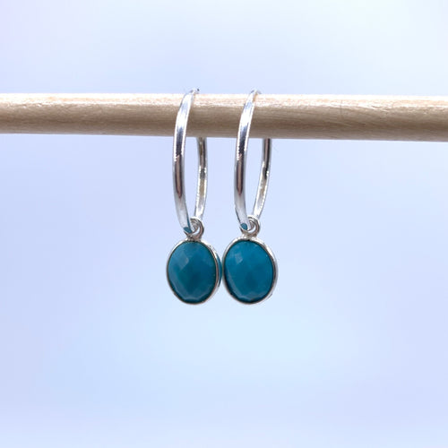 Gemstone earrings with turquoise (blue) oval crystal drops on silver small hoops