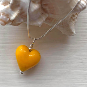 Necklace with dark yellow pastel Murano glass small heart pendant on silver snake chain