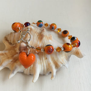 Bracelet with orange Murano glass mosaic beads, Swarovski© crystals and heart charm