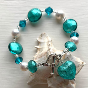 Bracelet with teal (green, jade) Murano glass beads, Swarovski© crystals, pearls, charm