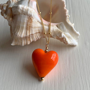 Necklace with orange pastel Murano glass medium heart pendant on gold satellite chain