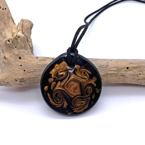Necklace with aventurine curls on black Murano glass near circular large flat pendant