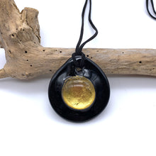 Necklace with clear crystal and gold on black Murano glass near circular large dome pendant