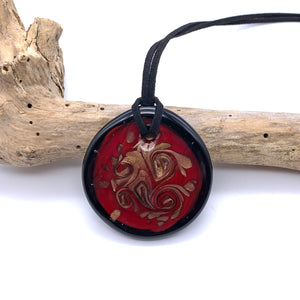 Necklace with red pastel and aventurine curls on black Murano glass circular large pendant