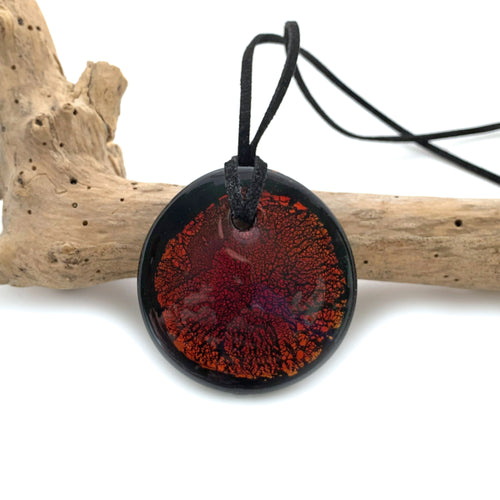 Necklace with burnt orange and gold on black Murano glass near circular large flat pendant