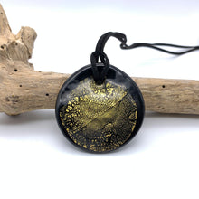 Necklace with clear crystal and gold on black Murano glass near circular large flat pendant