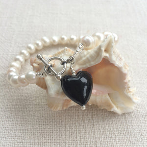 Bracelet with black pastel Murano glass small heart charm on white freshwater pearls