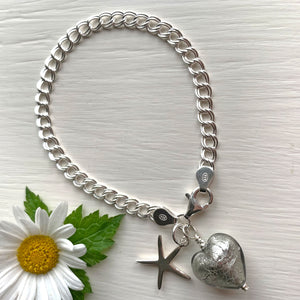 Bracelet with grey Murano glass small heart and starfish charms on silver curb chain