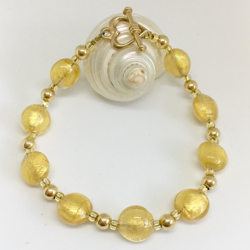 Bracelet with light (pale) gold Murano glass mini lentil beads on gold beads and clasp