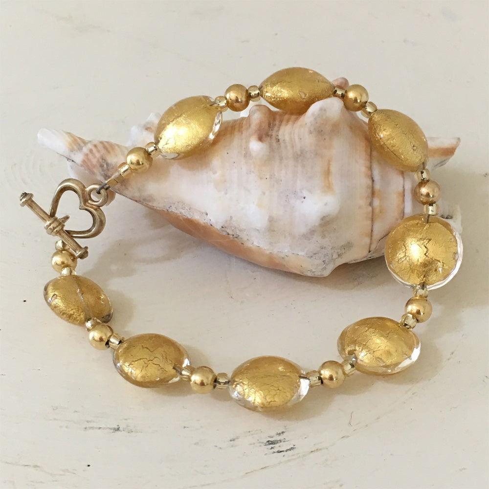 Bracelet with light (pale) gold Murano glass small lentil beads on gold beads and clasp