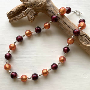 Necklace with burnt orange and dark amethyst Murano glass small sphere beads on silver