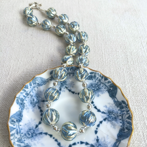 Necklace with cornflower blue appliqué over white gold Murano glass sphere beads on silver