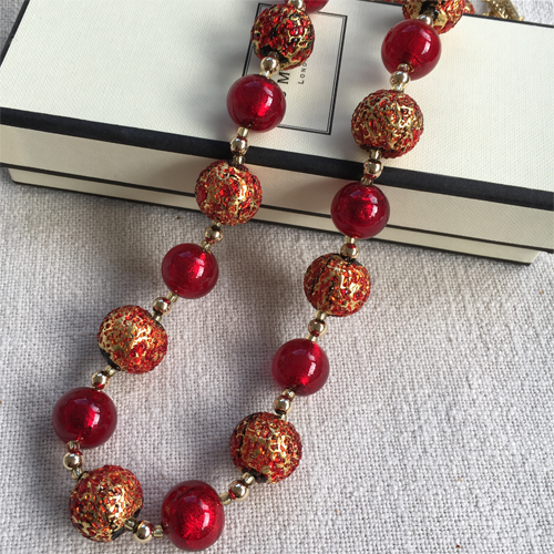 Necklace with speckled red and red Murano glass sphere beads on gold beads and clasp