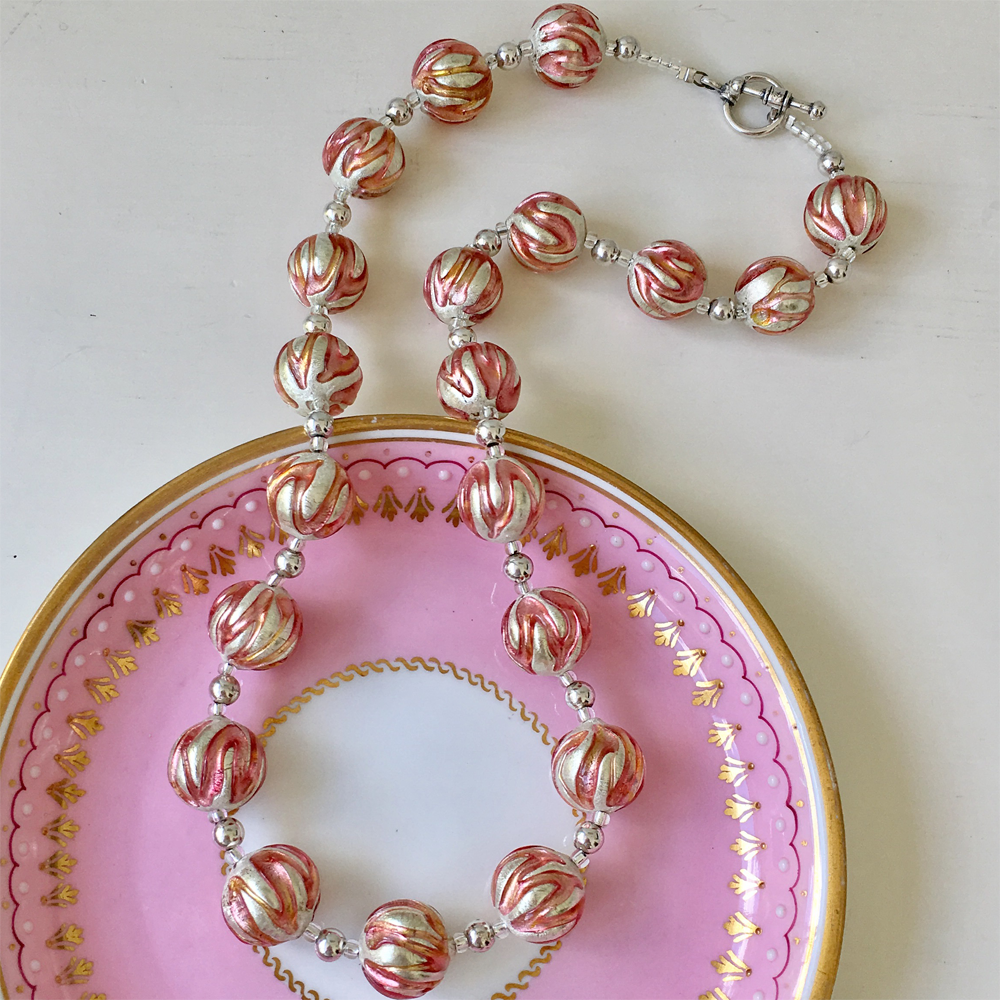Necklace with pink appliqué over white gold Murano glass sphere beads on silver