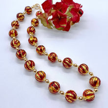 Necklace with red appliqué over gold Murano glass sphere beads on gold beads and clasp